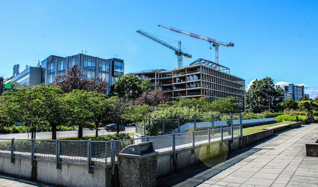 View of an apartment property under development across a park, representing BC property deals and default judgments